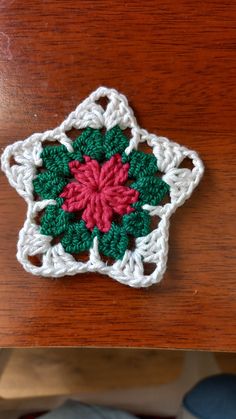 a crocheted ornament on top of a wooden table