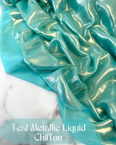 teal metallic liquid chiffon fabric on marble counter top with text overlay that reads, teal metallic liquid chiffon