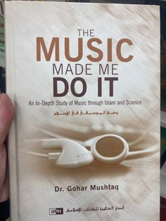 a person holding up a book about the music made me do it by dr gohar mushad