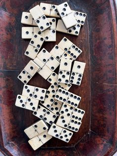 several dominos are arranged on a wooden tray