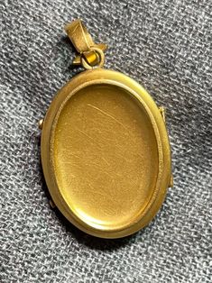 ". This beautiful oval locket has that gorgeous Victorian \"bloom\" to the gold that cannot be duplicated. It really can't be duplicated because the process has been illegal for almost 100 years now. The bale is an abstract fleur de lis shape. This locket is plated in 18k, thick enough to test 18k on the electronic tester! This locket does not have removable photo rings, but a printed picture could be carefully pressed in so it sits under the edge. I just print from my home printer on photo pape Classic Oval Locket Necklace Stamped 14k, Luxury Oval Locket Jewelry, Victorian Yellow Gold Oval Cabochon Jewelry, Victorian Oval Yellow Gold Jewelry, Victorian Yellow Gold Oval Jewelry, Yellow Gold Oval Link Locket Necklace, Gold 14k Oval Pendant Locket Necklace, Luxury Yellow Gold Oval Locket Necklace, Classic Antique Gold Oval Jewelry