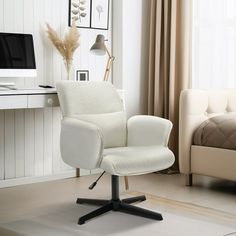 a white office chair sitting in front of a desk with a computer on top of it