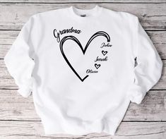 "HOW TO ORDER Custom Grandma Sweatshirt, Grandma Sweatshirt, Grandkids Name Shirt, Gift For Grandma, Women's Sweatshirt, Christmas Gift For Him 1. Select the shirt \"Style and Size\" 2.Select the shirt Color 3. Enter what would you like to say on your t shirt and LETTERING color 4.Select the quantity. 5. Click Add to cart.       If you have any difficulties, send us a message. Processing Time and Shipping The standard processing time is 1-3 business days. We usually proses and ship out the orders the next business day.   USA Orders: Standard : Takes 3 to 5 days to get delivered Priority : Takes 2 to 4 days to get delivered Express: Takes 1 to 2 days to get delivered    METERIALES High Quality Heat Transfer Vinyl, Unisex Shirt DESCRIPTION Please see the sizing chart for choosing your size t Long Sleeve T-shirt With Name Print Gift, White Long Sleeve Top For Gift, White Long Sleeve Top As Gift, White Long Sleeve Top As A Gift, Skier Gifts, Sweatshirt Ideas, Grandma Sweatshirt, Fall Designs, Christmas Gift For Him