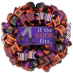 a halloween wreath with the words if the shoe fits written on it and candy wrapped in ribbon