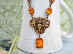 Beautiful Victorian style queen bee locket accented with vintage amber tone glass jewels on 18 inch antiqued brass chain with lobster clasp. All metal parts torch soldered together, darkened and sealed with coating. Please allow up to 3 days to make and ship for this piece. Measurement: Pendant is about 1.5 inch (38mm) and 2.2 inch (56mm) total in length, it hangs under on 18 inch chain. Or if you have a preferred length for the chain, please let me know in message to seller box and I will adjus Victorian Yellow Jewelry Gift, Victorian Yellow Jewelry For Gifts, Victorian Style Yellow Jewelry For Gift, Yellow Victorian Jewelry As A Gift, Vintage Yellow Jewelry For Gifts, Vintage Yellow Jewelry Gift, Vintage Yellow Jewelry For Gift, Vintage Yellow Jewelry As Gift, Vintage Yellow Pendant Jewelry