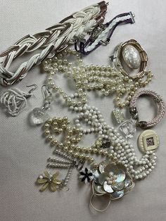 This is a 1/2 pound lot of broken and not, vintage and newer craft jewelry. The majority of these are wearable or for craft White tones There are necklaces, earrings, bracelets, key rings, broken pieces etc etc. Both vintage and modern. Perfect for your slow stitches or scrapbooking projects. Or other works of art This is NOT a mystery bag or box, so there will be no surprises You get everything in the picture. So study the pictures carefully !! Various materials such as plastic, metal, beads, e Assorted Adjustable Jewelry For Party, Adjustable Assorted Jewelry, Costume Jewelry For Accessorizing, Assorted Jewelry Making Supplies, Assorted Vintage Necklaces For Gifts, Vintage Handmade Assorted Jewelry, Vintage White Metal Jewelry, Handmade Vintage Jewelry In Assorted Colors, Vintage White Beaded Jewelry