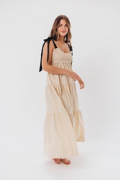 This dress is the perfect blend of femininity and contemporary comfort - meet the Amber Maxi Dress, a sweet and effortless gown for your next special event. We love its unique smocked bodice with a charming sweetheart neckline, plus self-tie shoulder straps in a sleek black hue. Pair this beauty with heels or slides and prepare yourself for the compliments! Available in two colorways. FIT: Runs true to size. Bodice is smocked and stretchy, but empire waist gives it a fitted structure that can be restricting for larger chests. Size up if you are between sizes. MATERIAL: GARMENT DETAILS: Lightweight maxi dress with empire-waisted silhouette and self-tie shoulder straps in contrasting color. Features a smocked bodice with sweetheart neckline, and a full, multi-tiered skirt. SIZE GUIDE: XS (0- Feminine Maxi Dress With Smocked Bodice And Empire Waist, Feminine Empire Waist Maxi Dress With Smocked Bodice, Garden Party Cotton Maxi Dress With Smocked Bodice, Cotton Maxi Dress With Smocked Bodice For Garden Party, Chic Smocked Maxi Dress With Ruched Details, Chic Maxi Length Smocked Dress With Ruched Details, Empire Waist Maxi Dress With Smocked Back For Brunch, Chic Smocked Dress With Fitted Bodice For Spring, Chic Maxi Dress With Smocked Bodice And Empire Waist