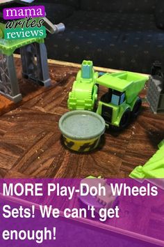 there is a play - doh wheel set on the table next to a toy truck