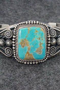 This beautiful and substantial Royston turquoise and sterling silver bracelet was made by Navajo silversmith Michael Calladitto. The back is signed M&R Calladitto, Navajo and stamped .925.Size: 5 1/2" (will fit up to a 6 7/8" wrist)Gap: 1 3/8"Width: 1 1/2"Free shipping on all orders! We ship with USPS and always include tracking. All orders ship within a day of payment.Returns are accepted up to 30 days after you receive your order. Just send us a message. Our shop offers cash back or store cred Artisan Turquoise Engraved Bracelets, Artisan Turquoise Engraved Bracelet, Artisan Turquoise Sterling Silver Bracelet, Bohemian Engraved Turquoise Sterling Silver Bracelet, Bohemian Turquoise Engraved Sterling Silver Bracelet, Unique Engraved Turquoise Bracelets, Artisan Sterling Silver Turquoise Bracelet Collectible, Handmade Turquoise Sterling Silver Southwestern Bracelet, Artisan Sterling Silver Bracelet