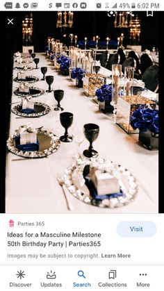 the table is set up for a party with blue and white decorations on it,