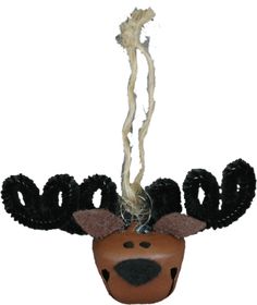 a deer head hanging from a string with black and white yarn on it's antlers