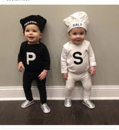 two toddlers dressed up as salt and pepper shakers standing next to each other