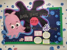 a bulletin board with an octopus and whale theme on it's side, surrounded by blue bubbles