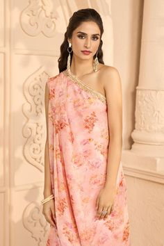 Peach one shoulder kurta with all-over floral prints. Comes with matching printed flared pant.
Components: 2
Pattern: Printed
Type Of Work: Floral Patterns
Neckline: One Shoulder
Sleeve Type: Sleeveless
Color: Peach
Other Details: 
Embroidered neckline
Front pleats kurta
Attached lining
Occasion: Mehendi and Haldi - Aza Fashions One Shoulder Dress With Zari Work For Designer Wear, One-shoulder Bollywood Dress With Zari Work, One Shoulder Bollywood Dress With Zari Work, Bollywood One Shoulder Dress With Zari Work, Bollywood Style One-shoulder Festive Dress, Bollywood One Shoulder Festive Dress, Bollywood One-shoulder Festive Dress, Bollywood Style One-shoulder Saree For Festive Occasions, Bollywood Style One Shoulder Saree For Festive Occasions