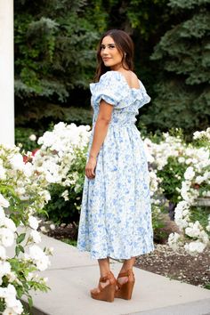 Warm days aren’t complete until you stroll in the Verona Dress. This dress features a beautiful blend of pastel blues and yellows to elevate your style and spirits. Statement sleeves and a full-length skirt add irresistible charm to your look, while the elastic waistline provides generous stretch and all-day comfort. This dress is perfect for soon-to-be mothers with bump-friendly ensembles. STYLE INFO & CARE The smocked bodice for a flexible, comfortable fit Skirt lined 100% polyester Maternity Blue Flowy Maxi Dress For Garden Party, Modest Light Blue Spring Dress, Light Blue Maxi Dress For Garden Party, Light Blue Sundress For Garden Party, Blue Flowy Skirt Dress For Garden Party, Blue Modest Dress For Garden Party, Blue Flowy Dress For Garden Party, Light Blue Flowy Dress For Garden Party, Modest Blue Dress For Garden Party