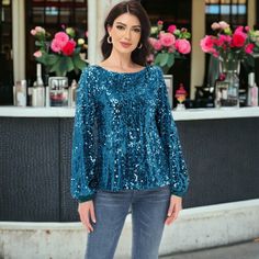 Step into the holiday season with style in the Anna-Kaci Women's Sequin Party Tie Waist Sweatshirt Pullover Top. This bedazzled pullover sweater features glittery sequins from top to bottom, combining festive sparkle with cozy comfort. With its round neckline, cuffed long sleeves, and relaxed fit, it's perfect for adding a touch of glamour to your winter wardrobe. Blue Long Sleeve Winter Blouse, Winter Party Sweater With Long Sleeves, Chic Sequined Tops For Holidays, Chic Holiday Sequined Tops, Chic Fall Party Sweater, Fall Party Blouse With Crew Neck, Glamorous Long Sleeve Winter Top, Winter Party Sweater With Crew Neck, Winter Long Sleeve Sequin Top