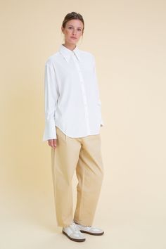 Our White Oversized Cuffs Shirt is made of 100% Viscose. The shirt features a pointed collar, button stand with handmade buttons and oversized cuffs with our signature button detail. This shirt has been designed with a beautiful blend of style and comfort, making it perfect for any occasion. Designed & manufactured in our own studio. Product code: AoS-SHWM017-1-WTVI ColorWhite 100% European Viscose Oversized fit with dropped shoulders Pointed collar Button-up front Handmade buttons Oversized cuf Oversized Office Tops With Spread Collar, Oversized Tops With Spread Collar For Office, Oversized Workwear Blouse With Spread Collar, Oversized Blouse With Spread Collar For Work, Cotton Office Blouse With Cuffed Sleeves, Classic Relaxed Fit Blouse With Cuffed Sleeves, Relaxed Fit Blouse With Cuffed Sleeves For Office, Classic Blouse With Relaxed Fit And Cuffed Sleeves, White Blouse For Workwear With Shirttail Hem