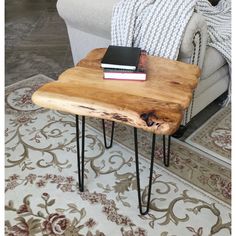 a wooden table sitting on top of a rug next to a couch