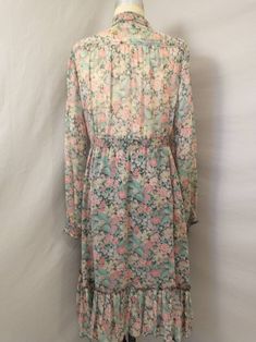 "Fun, classic vintage sixties midi dress - feminine floral. Black background with pink and blue flowers, green leaves. Sleeves and bodice are sheer and unlined (could wear with a black camisole) , skirt is lined with black. Label is and size says , Made in USA. Condition a bit rough, no stains but has pulling at seams in places. Elastic has lost most of its elasticity. Repair to seam on lining, fraying at wrist cuffs, pilling to fabric. Long sleeves. Length 46\" Shoulders 16\" Bust 40+ Waist 33\ Fitted Floral Print Prairie Dress Midi Length, Cottagecore Long Sleeve Vintage Dress With Floral Print, Fitted Midi-length Prairie Dress With Ruffles, Spring Floral Print Prairie Dress, Midi Length, 1970s Floral Dress, Black Camisole, Pink And Blue Flowers, Floral Dresses Long, Flowing Skirt