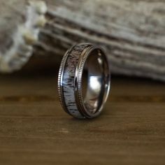 a wedding ring made out of silver and wood