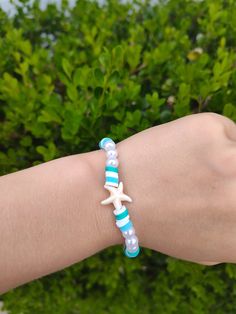 Cute blue and white combination bracelet with a starfish charm!! Blue Star Shaped Jewelry For Vacation, Blue Star Jewelry For Vacation, Blue Handmade Star-shaped Beaded Bracelets, Handmade Blue Star Bracelet, Handmade Blue Star-shaped Bracelet, Blue Bracelets With Starfish Charm Ocean-inspired, Ocean-inspired Blue Starfish Bracelets, Adjustable Blue Bracelets With Starfish Charm, Blue Beaded Bracelet With Starfish Charm