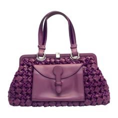 - Bottega Veneta classic intrecciato weave handle bag. Featuring purple velvet and leather shoulder strap handle. - The contrast of using an exterior leather pocket is such a good design because it shows that how functional the bag can be. - Silver hardware closure on top. - Purple leather and brown suede leather interior. Chanel Black Suede CC Turn-Lock Flap Handbag - Snap button interior pocket. - Length: 14 inches. Bag Height: 7 inches. Width: 6 inches. Handle Drop: 8 inches. Designer Purple Shoulder Bag With Detachable Handle, Luxury Purple Shoulder Bag With Double Handle, Bottega Veneta Bag Purple, Purple Leather-handled Tote Bag, Luxury Purple Shoulder Bag With Gold-tone Hardware, Velvet Purse, Suede Handbags, Purple Leather, Purple Velvet