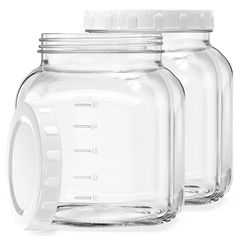 three empty glass jars with lids on white background