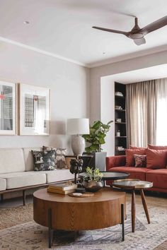 a living room filled with furniture and a ceiling fan