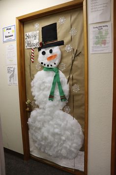 a snowman made out of foam sitting on top of a door