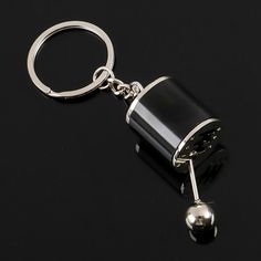 a black and silver keychain on a black surface