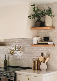 a kitchen with white brick walls and open shelving above the stove, surrounded by wooden shelves