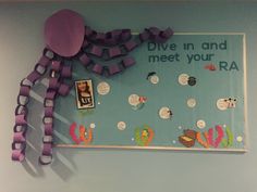 a bulletin board with purple ribbons attached to it and an image of a jellyfish