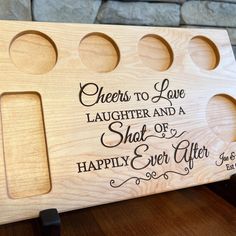 a wooden plaque with the words cheers to love laughter and a shot of happily ever after