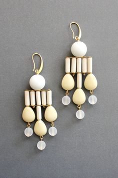 18k gold plated brass earrings with white agate, magnesite, acrylic, and glass. Each earring weighs .445oz and measures 3.625in from top of hook. Geometric Chandelier, White Agate, Earring Sale, Accessories Jewelry Earrings, Multi Strand Necklace, Brass Earrings, Chandelier Earrings, Light Accessories, Handmade Ceramics