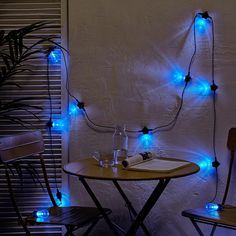 a table with two chairs and some lights on it