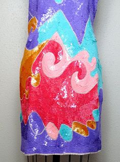 "Such an eye-catching vintage party dress! It's fully embellished with bright pastel sequins and white beading in this AMAZING retro design. It's in absolutely perfect condition!! Measurements: Bust - 31\" Waist - 25\" Hips - 34\" Length - 34\" Size - fits like XS, please refer to measurements for accurate sizing This dress comes from a pet-free and smoke-free home. I'm happy to answer any questions! Thanks for looking!" Disco Style Sequined Festival Dresses, Disco Style Sequined Dresses For Festivals, Multicolor Sequined Disco Dresses, Festival Fitted Sequin Dresses, Fitted Sequin Festival Dresses, Multicolor Festival Dresses For Party, Sequin Dress For Carnival Costume Party, Sequin Dress For Costume Party And Carnival, Fitted Embellished Festival Dress