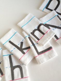 several napkins with the letters dk and k on them sitting next to each other