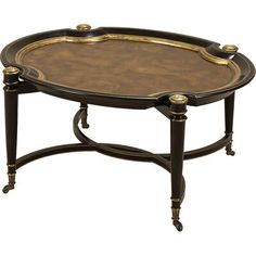 an ornately decorated coffee table with gold trimmings on the top and bottom