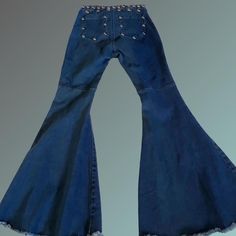 Custom Roncelli / 70s Style Dome Studded Super Flare  Bell Bottom Jeans *Size Small *High Waisted  *Stretchy Slimming Dark Blue Denim *Steel/ Chrome Dome Large Studs  *Super Wide Flare / Bell Bottom With Reinforced Frayed Hem *Excellent condition Approximate Flat Measurements: Waist 13" (up to 15" max when stretched)  Doubled = 26" (up to 30" max when stretched) Flare 17.5"  Crotch to bottom 29" Total length 40" "just in case" spare studs included with order (in the very rare case your festival partying causes you to lose one somehow, or perhaps get creative and adorn something else you own with the spares such as a matching choker or attach to a top you wear with the pants ) Wide-leg Cotton Bottoms For Concerts, Cotton Wide Leg Bottoms For Concerts, Retro Stretch Denim Blue Flare Jeans, Grunge Full-length Denim Flare Jeans, Grunge Full Length Denim Flare Jeans, Denim Bottoms For Fall Festivals, Retro High Waist Flare Jeans For Fall, Grunge High Rise Medium Wash Flare Jeans, Retro Stretch Flare Denim Jeans