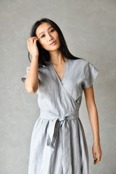 "PENELOPE wrap linen dress is a beautiful style dress with functional side pockets and a drop shoulder design. Perfect as a summer dress it has a long attached belt you can wrap around your waist. Made from 100% linen fabric PENELOPE dress is very body-flattering and we offer it in plus sizes up to 4XL.  ▶ FIT PENELOPE linen dress is true to size design. We recommend choosing your usual size to have a fit like the one shown on the model. ▸ The model is wearing size XS, Color Light Gray ▶ FABRIC: Elegant V-neck Linen Dress With Pockets, Casual Linen V-neck Wrap Dress, Linen Dress With Tie Waist And Surplice Neckline, Relaxed Fit V-neck Linen Dress With Pockets, Summer Linen V-neck Dress With Pockets, Beach Linen Dress With Surplice Neckline, Linen Dress With Tie Waist And Short Sleeves, Summer V-neck Linen Dress With Pockets, Spring Linen Dress With Surplice Neckline