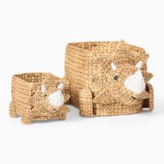 two baskets with animals made out of straw