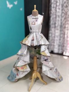 a dress made out of newspapers sitting on top of a table