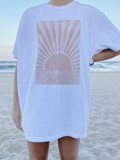 "The PERFECT summer graphic tee! Comfort Colors white t-shirt with a sun design. Model is 5'4\" and wearing a size XL for an oversized look. 100% cotton." Sun Graphic, Summer Graphic Tee, Sun Design, White Comforter, Sun Designs, Summer Glow, Tee Shirt Designs, Comfort Colors Tee, Star Shirt