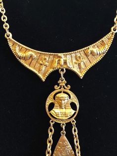 Vintage ART Egyptian Revival Tassel Dangle Faux Gems Charm Necklace Signed | eBay Traditional Jewelry With Historical Design For Collectors, Ceremonial Pendant Necklace With Vintage Charm, Ceremonial Yellow Gold Necklace With Historical Design, Traditional Brass Necklaces For Collectors, Traditional Brass Collectible Necklaces, Vintage Pendant Necklace With Historical Design, Bohemian Gold Jewelry With Historical Design, Vintage Ankh Necklace In Metal, Vintage Ankh Metal Necklace