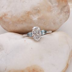 a diamond ring sitting on top of a rock