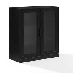 a black cabinet with two glass doors on the front and bottom, sitting on a white surface