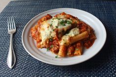 a white plate topped with pasta covered in sauce