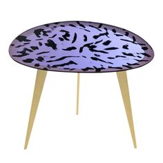 an animal print table with wooden legs and a purple surface on the top, in front of a white background