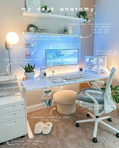 a computer desk with a monitor, keyboard and headphones in front of the screen