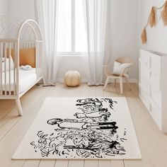 a baby's room with white walls and wood flooring is decorated in black and white